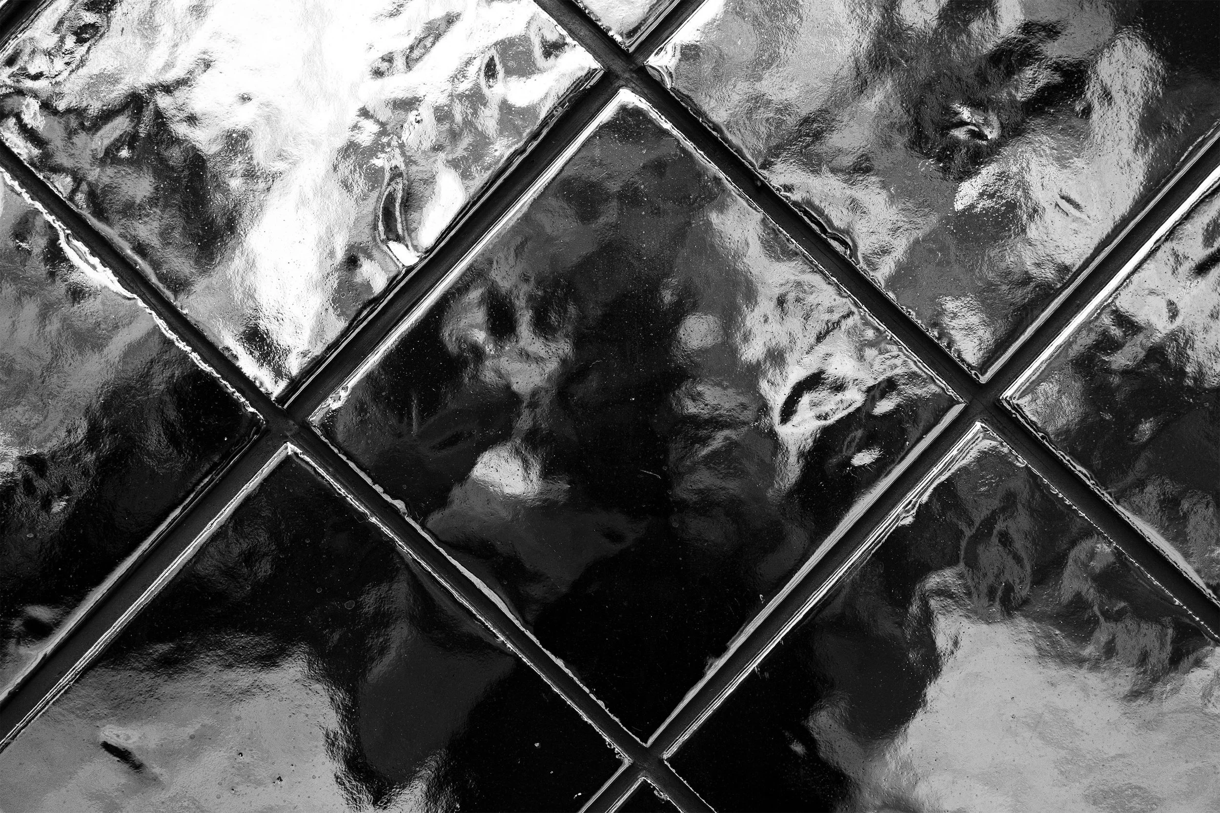 Light and reflections through glass blocks, in black and white